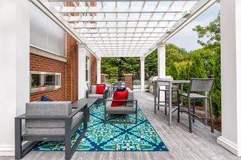 Outdoor patio with grills and dining seating, fireplace